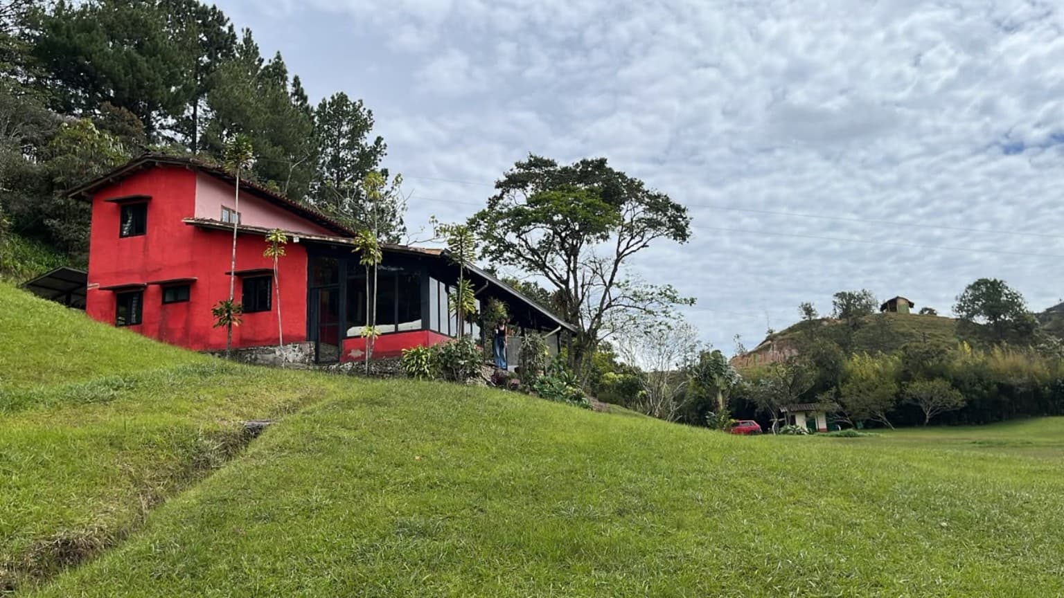 La Julia's red facade and veranda beside the lawn