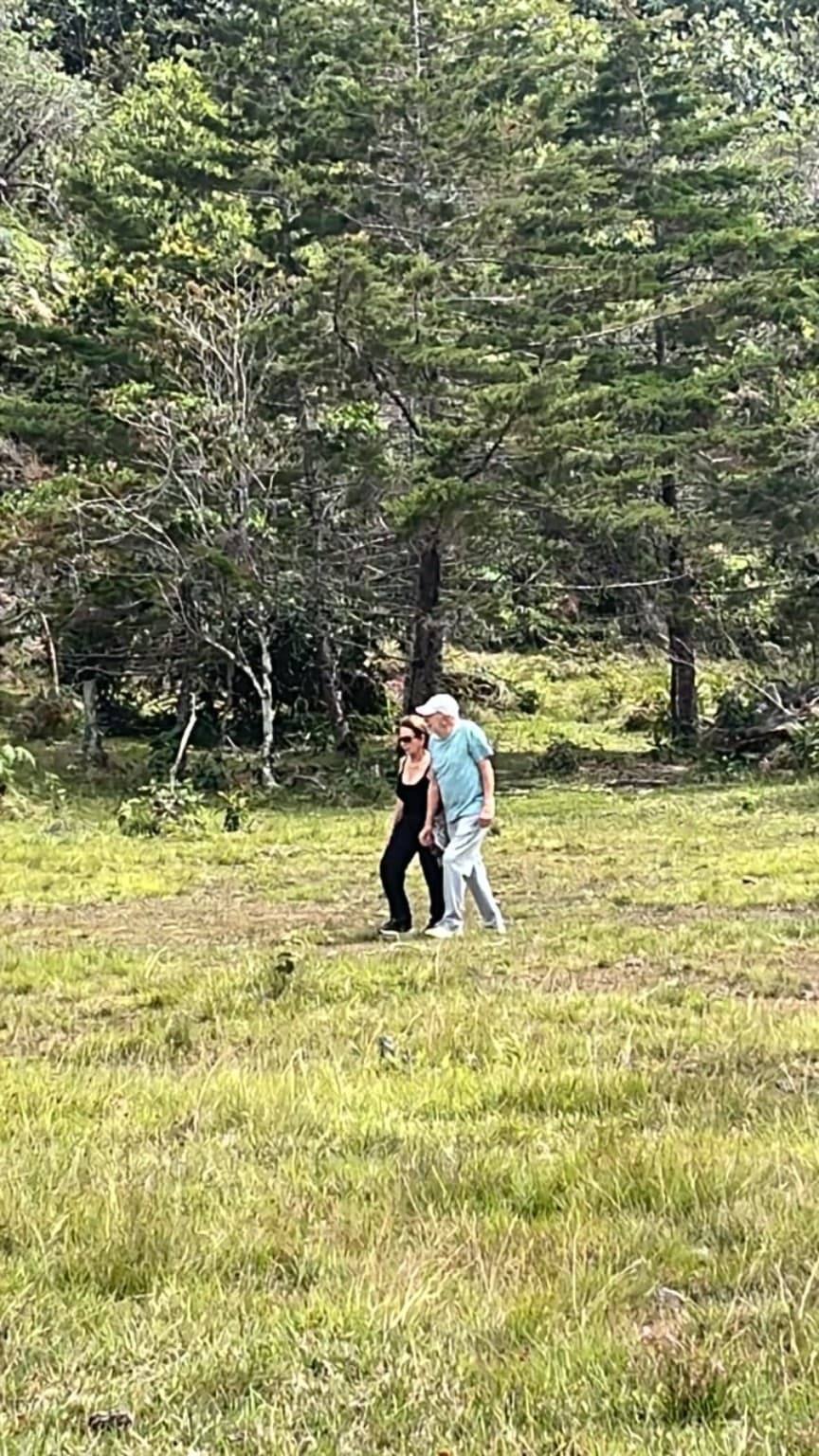 Two guests walking through La Julia's landscape