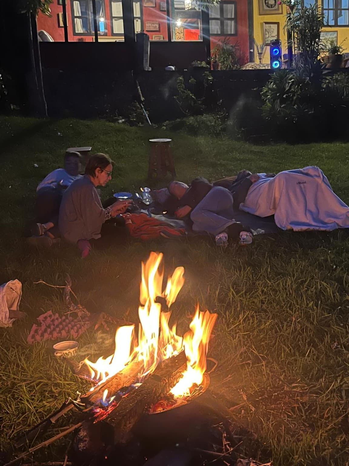 A group resting beside a bonfire at La Julia