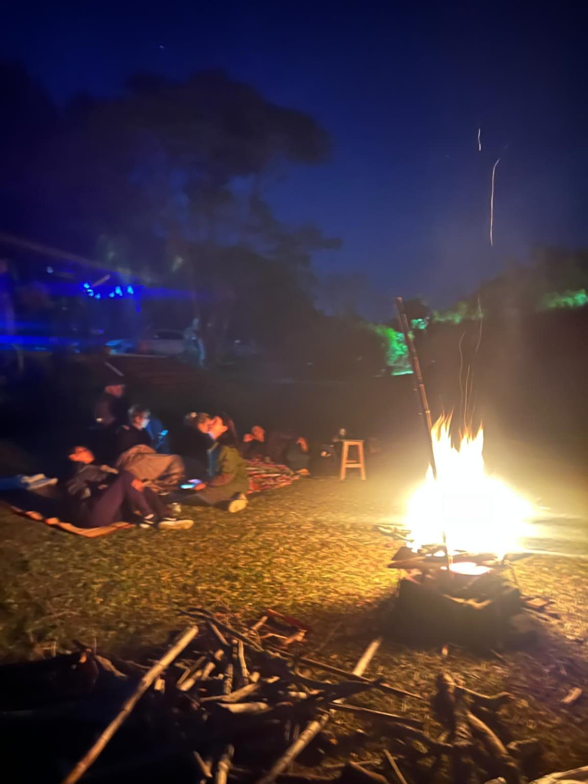 Wide view of a group gathered around the fire at La Julia