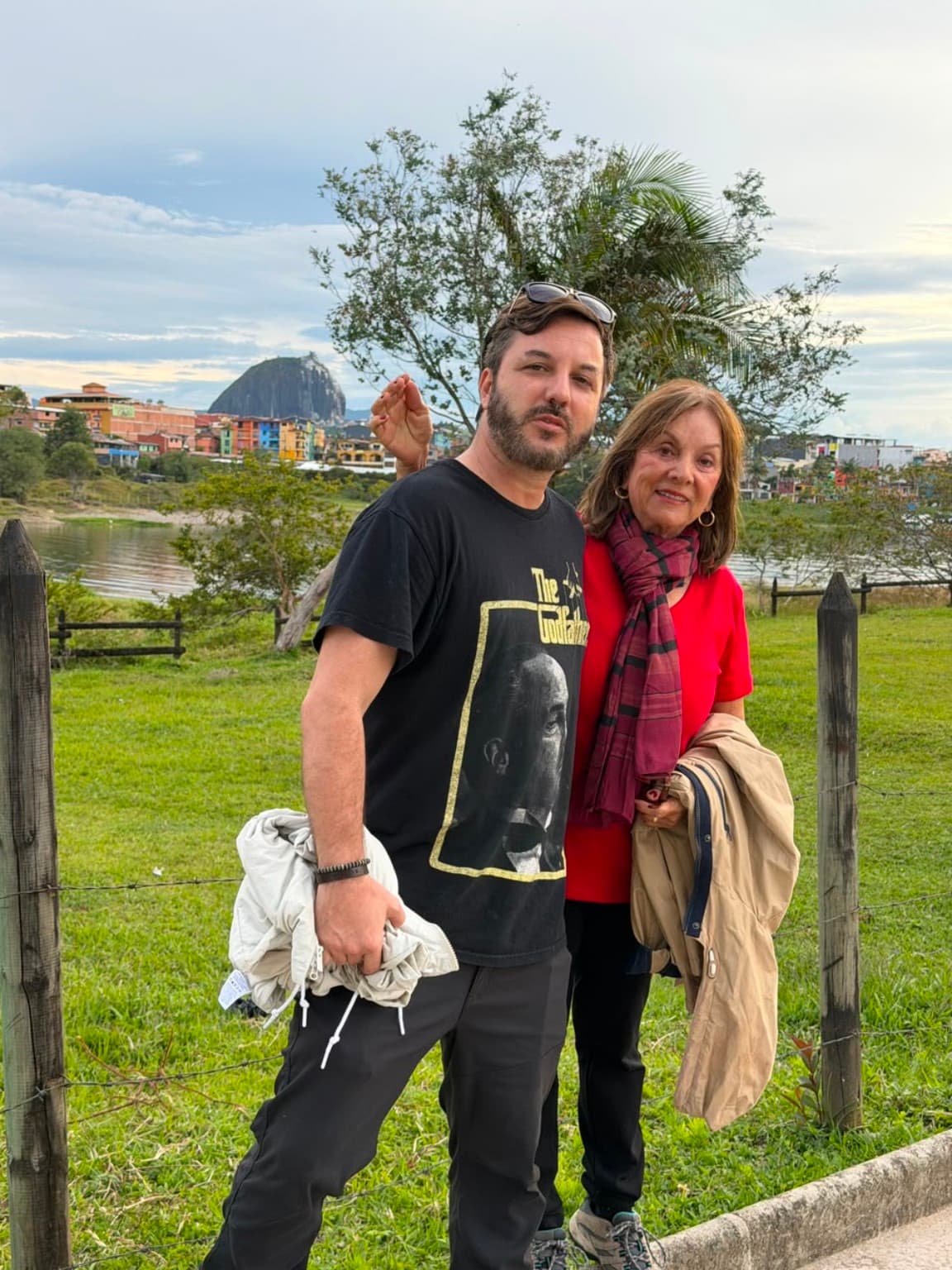 Visitors in Guatapé with El Peñol in the background