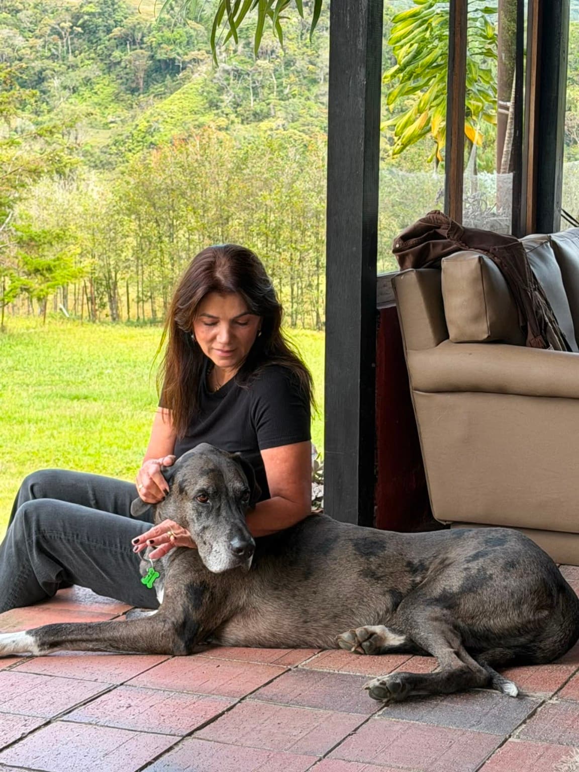 A guest with a Great Dane on La Julia's veranda